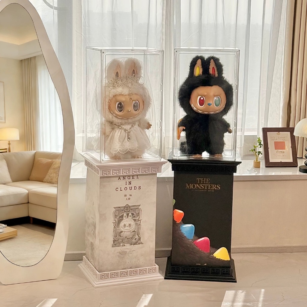 Stackable clear acrylic display cubes holding plush collectibles on a sideboard