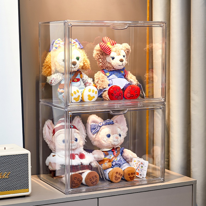 Tall acrylic display case on a pedestal showing a large plush figure inside